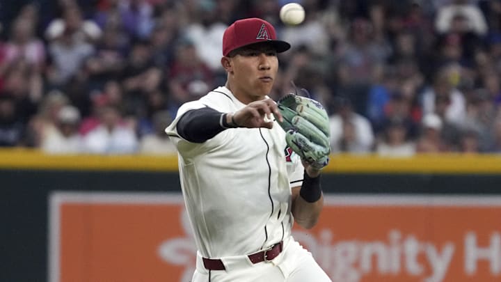 Mar 31, 2026; Phoenix, Arizona, USA; Arizona Diamondbacks third baseman Jose Fernandez (11) makes the off balance throw for an out against the Detroit Tigers in the first inning at Chase Field. Mandatory Credit: Rick Scuteri-Imagn Images