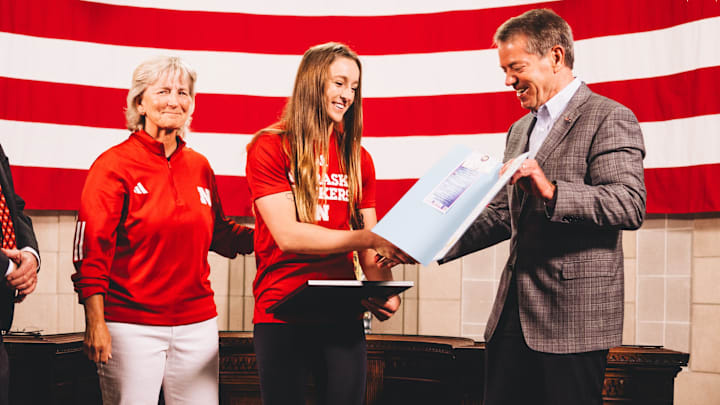 Nebraska softball pitcher/utility player Jordy Bahl with coach Rhonda Revelle and Gov. Jim Pillen.