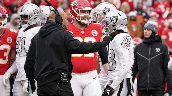 Dec 25, 2023; Kansas City, Missouri, USA; Las Vegas Raiders interim head coach Antonio Pierce separates cornerback Jack Jones (18) from Kansas City Chiefs center Creed Humphrey (52) during the game at GEHA Field at Arrowhead Stadium. Mandatory Credit: Denny Medley-USA TODAY Sports