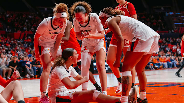 Members of the Illinois women's basketball team celebrate a big play in the Illini's 73-70 win over No. 7 Maryland on Thursday at the State Farm Center in Champaign, Illinois.
