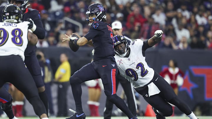 Dec 15, 2024; Houston, Texas, USA; Houston Texans quarterback C.J. Stroud (7) throws the ball as Baltimore Ravens defensive tackle Nnamdi Madubuike (92) attempts to make a tackle during the second quarter at NRG Stadium. Mandatory Credit: Troy Taormina-Imagn Images
