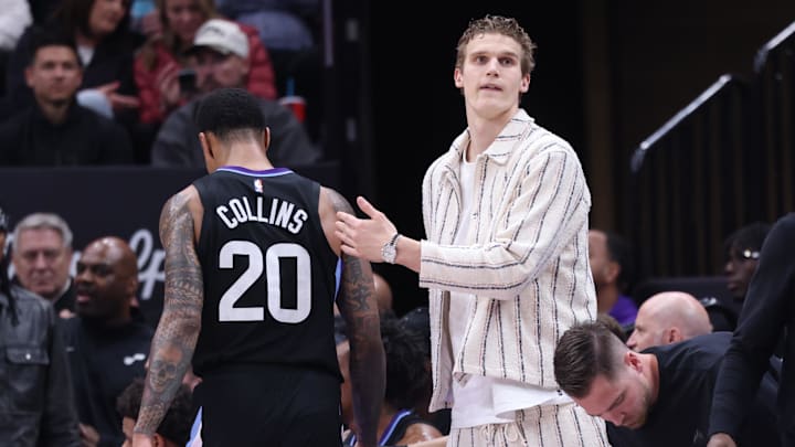 Feb 28, 2025; Salt Lake City, Utah, USA; Utah Jazz forward Lauri Markkanen (right) reacts to forward John Collins heading to the bench during the second half at Delta Center. Mandatory Credit: Rob Gray-Imagn Images