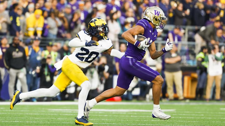 Oct 5, 2024; Seattle, Washington, USA; Michigan Wolverines defensive back Jyaire Hill (20) tackles Washington Huskies wide receiver Denzel Boston (12) following a reception by Boston during the second quarter at Alaska Airlines Field at Husky Stadium. Mandatory Credit: Joe Nicholson-Imagn Images