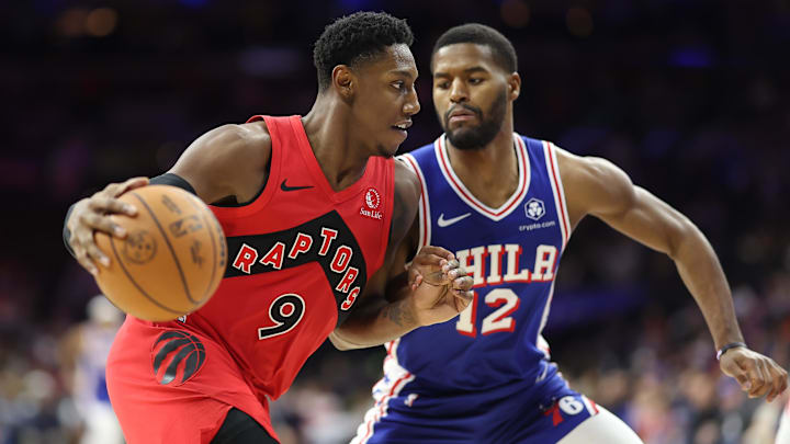 Mar 30, 2025; Philadelphia, Pennsylvania, USA; Toronto Raptors guard RJ Barrett (9) drives against Philadelphia 76ers guard Jared Butler (12) during the fourth quarter at Wells Fargo Center. Mandatory Credit: Bill Streicher-Imagn Images