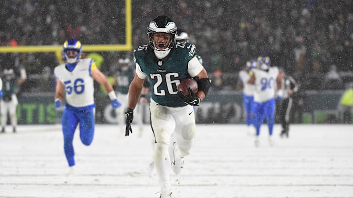 Philadelphia Eagles running back Saquon Barkley (26) carries the ball to score a touchdown against the Los Angeles Rams in the second half in a 2025 NFC divisional round game at Lincoln Financial Field.