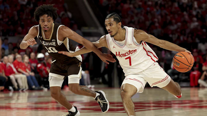Houston Cougars guard Milos Uzan (7) drives against Lehigh Mountain Hawks guard Caleb Thomas (10) during the first half at Fertitta Center.