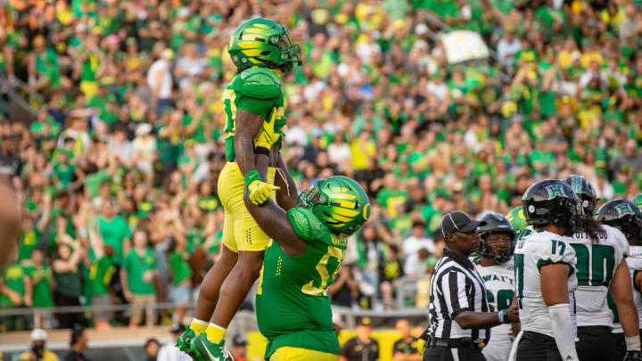 Oregon running back Jordan James is lifted into the air by teammate Marcus Harper II to celebrate a touchdown as the Oregon Ducks host Hawaii Saturday, Sept. 16, 2023, at Hayward Field in Eugene, Ore. Oregon running back Jordan James is lifted into the air by teammate Marcus Harper II to celebrate a touchdown as the Oregon Ducks host Hawaii Saturday, Sept. 16, 2023, at Hayward Field in Eugene, Ore.