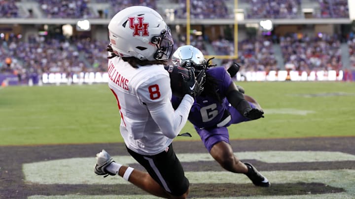 Oct 4, 2024; Fort Worth, Texas, USA; Houston Cougars wide receiver Devan Williams (8) catches a touchdown pass against TCU Horned Frogs cornerback LaMareon James (6) in the first quarter at Amon G. Carter Stadium. 