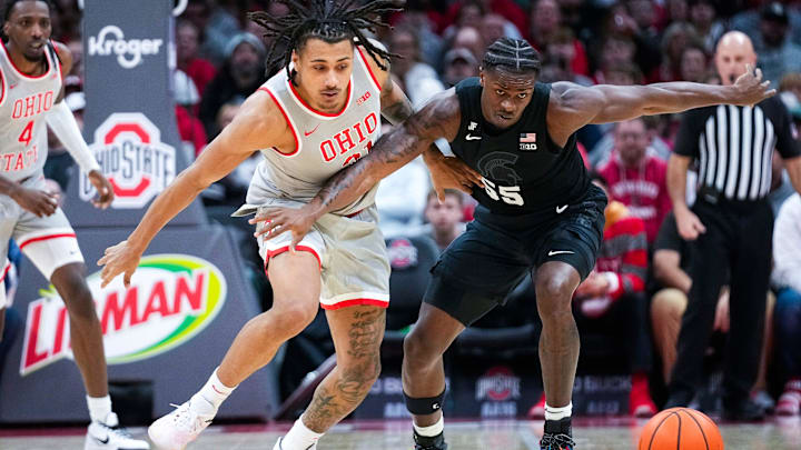 Ohio State Buckeyes forward Devin Royal (21) fights for the ball against Michigan State Spartans forward Coen Carr (55) in the first half at Value City Arena on Friday, Jan. 3, 2025 in Columbus, Ohio.