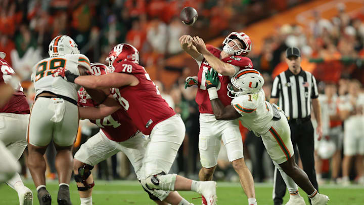 Jan 19, 2026; Miami Gardens, FL, USA; Miami Hurricanes linebacker Mohamed Toure (1) tackles Indiana Hoosiers quarterback Fernando Mendoza (15) after a pass in the first quarter during the College Football Playoff National Championship game at Hard Rock Stadium. Mandatory Credit: Sam Navarro-Imagn Images