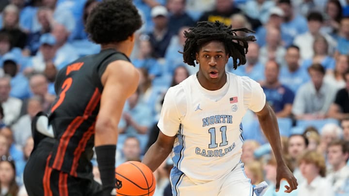 Mar 1, 2025; Chapel Hill, North Carolina, USA;  North Carolina Tar Heels guard Ian Jackson (11) brings the ball up the court as Miami (Fl) Hurricanes guard Jalil Bethea (3) defends in the second half at Dean E. Smith Center. Mandatory Credit: Bob Donnan-Imagn Images