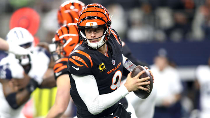 Dec 9, 2024; Arlington, Texas, USA; Cincinnati Bengals quarterback Joe Burrow (9) rolls out to pass against the Dallas Cowboys in the first quarter at AT&T Stadium. Mandatory Credit: Tim Heitman-Imagn Images