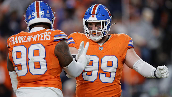 Nov 6, 2025; Denver, Colorado, USA; Denver Broncos defensive end Zach Allen (99) reacts with defensive end John Franklin-Myers (98) during the first half at Empower Field at Mile High. 