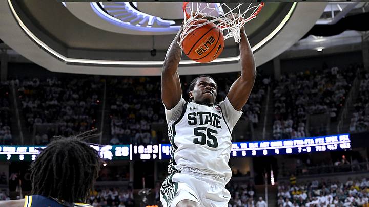 Jan 30, 2026; East Lansing, Michigan, USA;  Michigan State Spartans forward Coen Carr (55) dunks against Michigan Wolverines forward Morez Johnson Jr. (21) during the second half at Jack Breslin Student Events Center. Mandatory Credit: Dale Young-Imagn Images