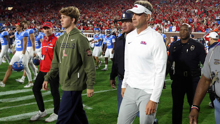 Nov 15, 2025; Oxford, Mississippi, USA; Mississippi Rebels head coach Lane Kiffin and his son, Knox Kiffin, walk onto the field after defeating the Florida Gators at Vaught-Hemingway Stadium. Mandatory Credit: Petre Thomas-Imagn Images