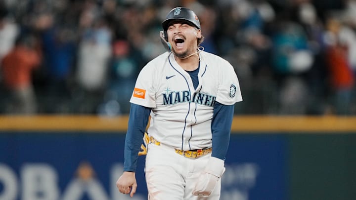 Oct 17, 2025; Seattle, Washington, USA; Seattle Mariners first baseman Josh Naylor (12) reacts after third baseman Eugenio Suarez (not pictured) hits a grand slam against the Toronto Blue Jays in the eighth inning during game five of the ALCS round for the 2025 MLB playoffs at T-Mobile Park. Mandatory Credit: Stephen Brashear-Imagn Images