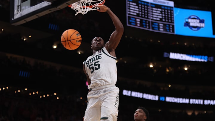 Mar 28, 2025; Atlanta, GA, USA; Michigan State Spartans forward Coen Carr (55) dunks against Mississippi Rebels forward Malik Dia (0) in the second half of a South Regional semifinal of the 2025 NCAA tournament at State Farm Arena. Mandatory Credit: Brett Davis-Imagn Images