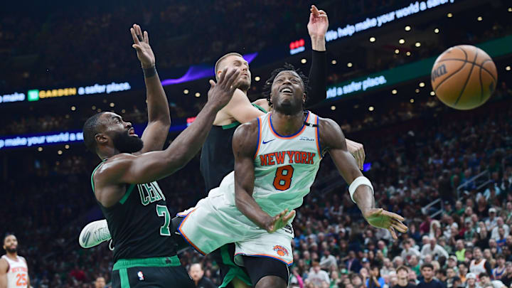 May 14, 2025; Boston, Massachusetts, USA; New York Knicks forward OG Anunoby (8) loses the ball between Boston Celtics guard Jaylen Brown (7) and center Kristaps Porzingis (8) in the first half during game five of the second round for the 2025 NBA Playoffs at TD Garden. Mandatory Credit: Bob DeChiara-Imagn Images