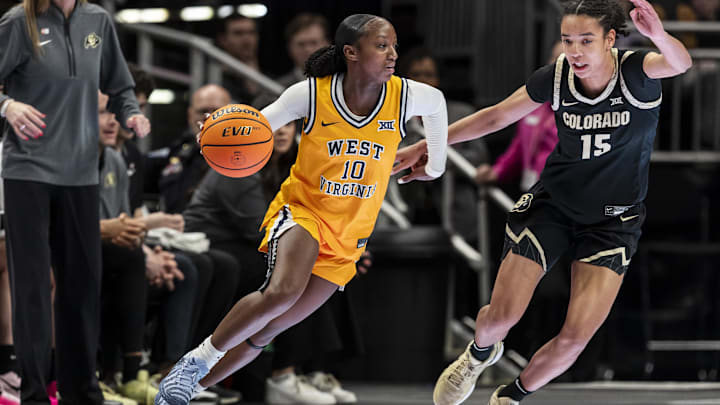 Mar 7, 2026; Kansas City, MO, USA; West Virginia Mountaineers guard Jordan Harrison (10) attempts to drive around Colorado Buffaloes forward Anaëlle Dutat (15) during the first half at T-Mobile Center. Mandatory Credit: Nick Tre. Smith-Imagn Images Mar 7, 2026; Kansas City, MO, USA; West Virginia Mountaineers guard Jordan Harrison (10) attempts to drive around Colorado Buffaloes forward Anaëlle Dutat (15) during the first half at T-Mobile Center. Mandatory Credit: Nick Tre. Smith-Imagn Images