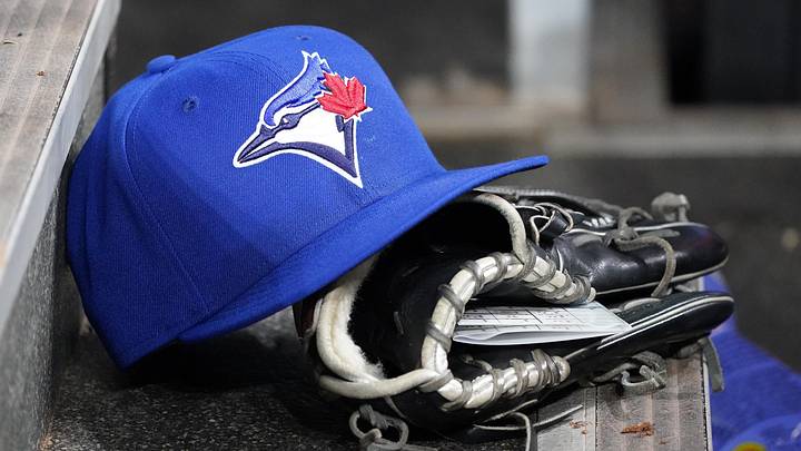 Apr 16, 2025; Toronto, Ontario, CAN; A Toronto Blue Jays hat and glove in the dugout during a game against the Atlanta Braves at Rogers Centre. Mandatory Credit: John E. Sokolowski-Imagn Images