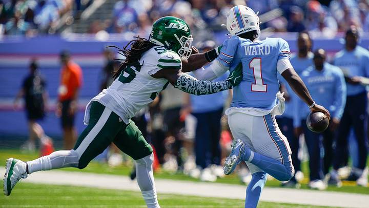 Tennessee Titans quarterback Cam Ward (1) is forced out of bounds by New York Jets linebacker Demario Davis (56) during the third quarter at Nissan Stadium in Nashville, Tenn., Sunday, Sept. 13, 2026. Tennessee Titans quarterback Cam Ward (1) is forced out of bounds by New York Jets linebacker Demario Davis (56) during the third quarter at Nissan Stadium in Nashville, Tenn., Sunday, Sept. 13, 2026.