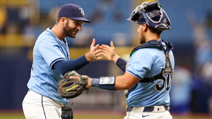 Apr 18, 2024; St. Petersburg, Florida, USA;  Tampa Bay Rays pitcher Colin Poche (38) and catcher Rene Pinto (50) celebrate after beating the Los Angeles Angels at Tropicana Field. Mandatory Credit: Nathan Ray Seebeck-Imagn Images
