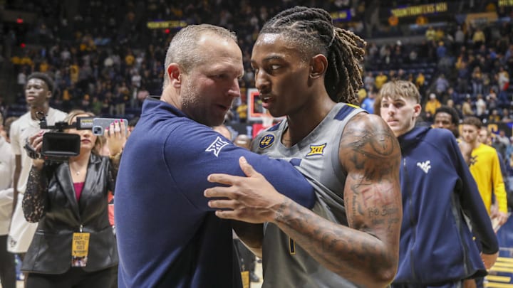 Mar 8, 2025; Morgantown, West Virginia, USA; West Virginia Mountaineers head coach Darian DeVries and guard Javon Small (7) celebrate after defeating the UCF Knights at WVU Coliseum. Mandatory Credit: Ben Queen-Imagn Images