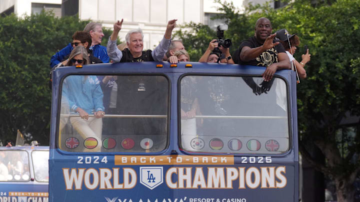 Nov 3, 2025; Los Angeles, CA, USA;  Los Angeles Dodgers owner Mark Walter and Magic Johnson wave to fans during the World Series championship parade and celebration. Mandatory Credit: Kirby Lee-Imagn Images
