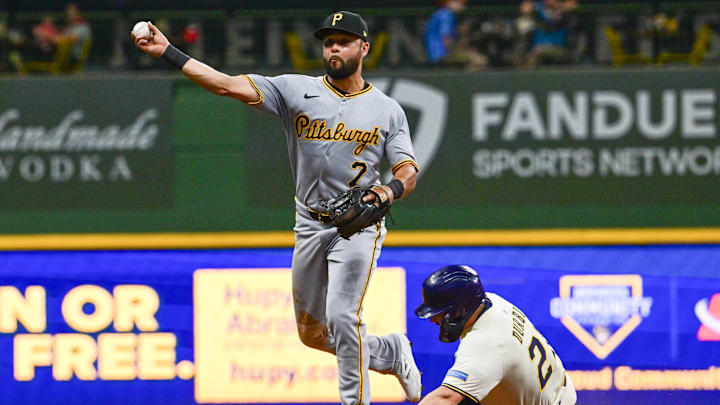 Jun 24, 2025; Milwaukee, Wisconsin, USA; Pittsburgh Pirates shortstop Isiah Kiner-Falefa attempts a double play after forcing out Milwaukee Brewers third baseman Caleb Durbin (21) in the eighth inning at American Family Field. Mandatory Credit: Benny Sieu-Imagn Images