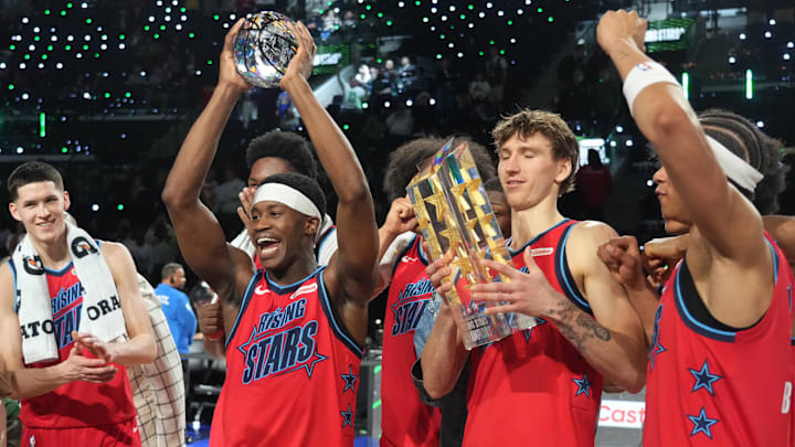 Feb 13, 2026; Inglewood, California, USA; Team Vince guard VJ Edgecombe (77) of the Philadelphia 76ers reacts with the MVP trophy after defeating Team Melo during an NBA All Star Rising Stars championship game at Intuit Dome. Mandatory Credit: Kirby Lee-Imagn Images Feb 13, 2026; Inglewood, California, USA; Team Vince guard VJ Edgecombe (77) of the Philadelphia 76ers reacts with the MVP trophy after defeating Team Melo during an NBA All Star Rising Stars championship game at Intuit Dome. Mandatory Credit: Kirby Lee-Imagn Images