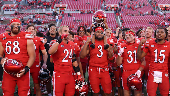 The Utah Utes celebrate a win over the Cal Poly Mustangs after the game at Rice-Eccles Stadium.