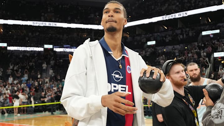 San Antonio Spurs center Victor Wembanyama (1) prepares to throw a ball in to the stands in celebration of Fan Appreciation Day after a victory over the Toronto Raptors at Frost Bank Center.