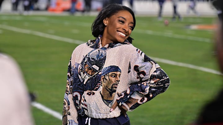 Simone Biles poses for a photo on the sidelines before the game between the Chicago Bears and the Seattle Seahawks. Simone Biles poses for a photo on the sidelines before the game between the Chicago Bears and the Seattle Seahawks.