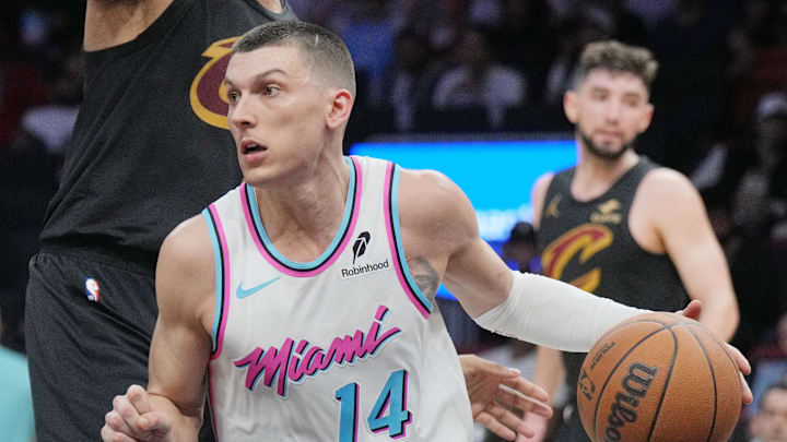 Jan 29, 2025; Miami, Florida, USA;  Miami Heat guard Tyler Herro (14) looks to pass the ball as Cleveland Cavaliers guard Caris LeVert (3) defends during the second half at Kaseya Center. Mandatory Credit: Jim Rassol-Imagn Images