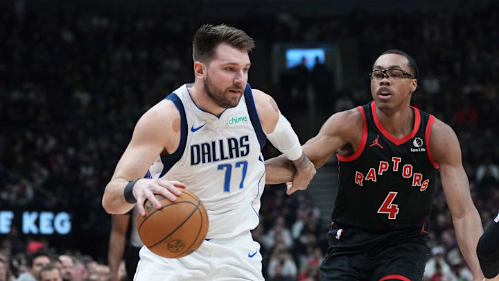 Dec 7, 2024; Toronto, Ontario, CAN; Dallas Mavericks guard Luka Doncic (77) drives to the basket against Toronto Raptors forward Scottie Barnes (4) during the first quarter at Scotiabank Arena. Mandatory Credit: Nick Turchiaro-Imagn Images