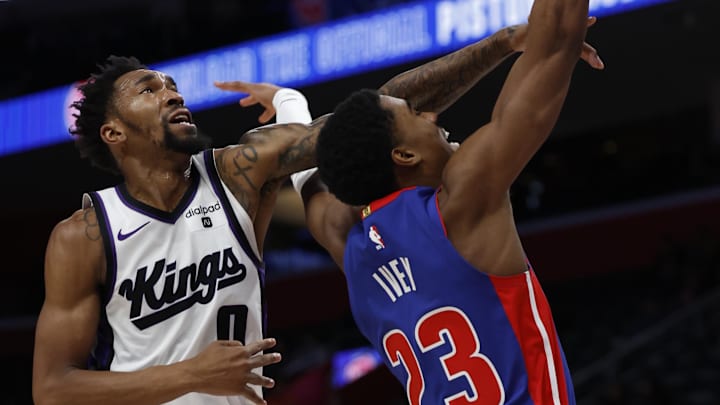 Jan 9, 2024; Detroit, Michigan, USA;  Detroit Pistons guard Jaden Ivey (23) shoots and is fouled by Sacramento Kings guard Malik Monk (0) in the second half at Little Caesars Arena. Mandatory Credit: Rick Osentoski-Imagn Images