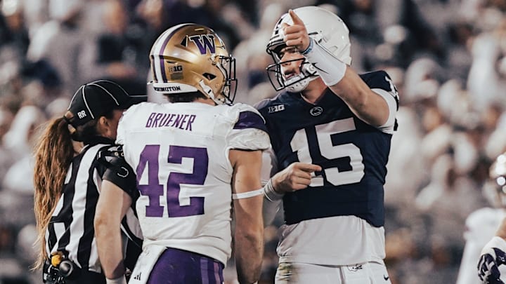 UW linebacker Carson Bruener gets into it with Penn State quarterback Drew Allar while an official tries to intervene. 