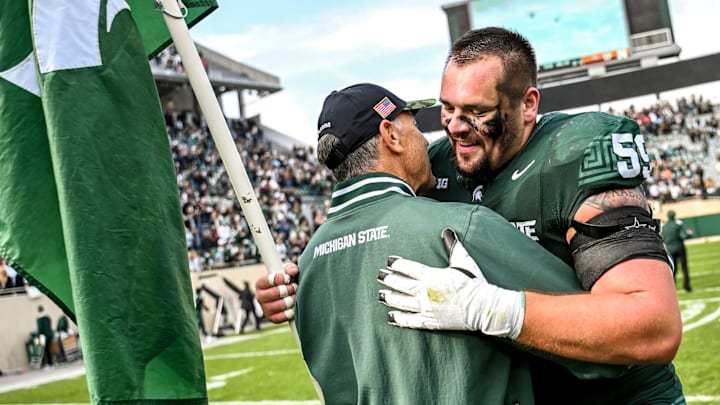 Michigan State's Nick Samac, right, hugs former head coach Mark Dantonio after beating Nebraska on