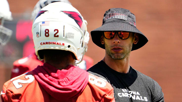 Arizona Cardinals head coach Jonathan Gannon talks to wide receiver Andre Baccellia (82) during