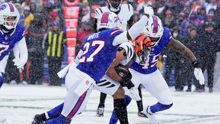 Cincinnati Bengals wide receiver Andrei Iosivas gets tackled by Buffalo Bills cornerback Tre'Davious White and linebacker Shaq Thompson during first half action at Highmark Stadium in Orchard Park on Dec. 7, 2025. Cincinnati Bengals wide receiver Andrei Iosivas gets tackled by Buffalo Bills cornerback Tre'Davious White and linebacker Shaq Thompson during first half action at Highmark Stadium in Orchard Park on Dec. 7, 2025.