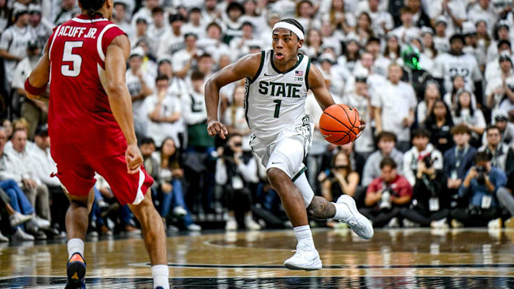 Michigan State's Jeremy Fears Jr. moves the ball as Arkansas' Darius Acuff Jr., left, defends during the first half on Saturday, Nov. 8, 2025, at the Breslin Center in East Lansing.