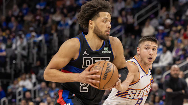 Jan 18, 2025; Detroit, Michigan, USA; Detroit Pistons guard Cade Cunningham (2) drives to the basket against Phoenix Suns guard Grayson Allen (8) during the second quarter at Little Caesars Arena. Mandatory Credit: David Reginek-Imagn Images