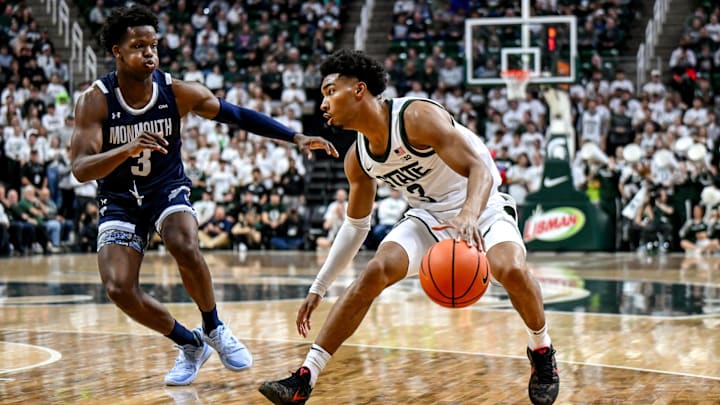 Michigan State's Jaden Akins, right, moves the ball as Monmouth's Madison Durr defends during the first half on Monday, Nov. 4, 2024, at the Breslin Center in East Lansing.