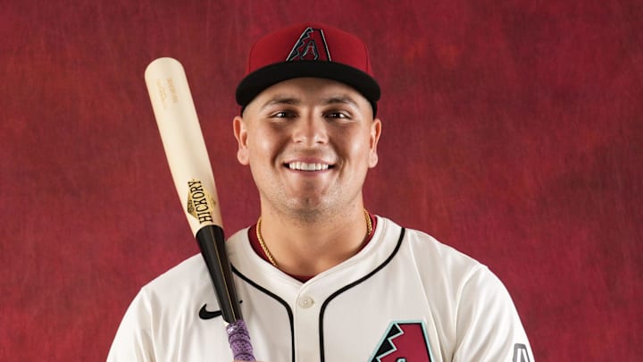 Ivan Melendez holds a bat during photo day at Salt River Fields at Talking Stick on Feb. 21, 2024.