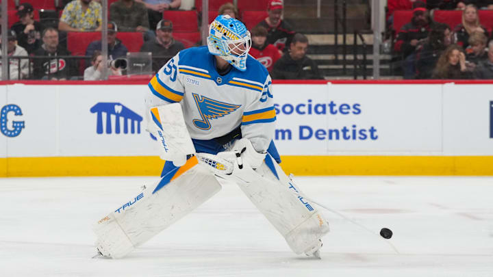 Mar 12, 2026; Raleigh, North Carolina, USA;  St. Louis Blues goaltender Jordan Binnington (50) clears the puck away against the Carolina Hurricanes during the first period at Lenovo Center. Mandatory Credit: James Guillory-Imagn Images