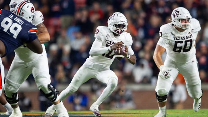 Texas A&M Aggies quarterback Marcel Reed (10) runs the ball as Auburn Tigers take on Texas A&M Aggies at Jordan-Hare Stadium in Auburn, Ala., on Saturday, Nov. 23, 2024. Auburn Tigers lead Texas A&M Aggies 21-7 at halftime.