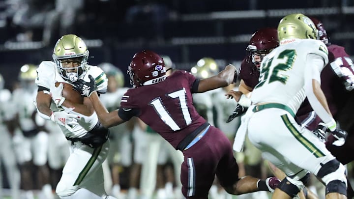 Benedictine's Isaiah Jones grabs Ware County running back Jamir Boyd on Friday October 11, 2024 at Memorial Stadium.