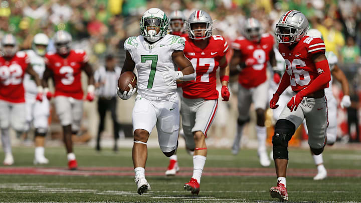 Oregon Ducks running back CJ Verdell (7) runs past Ohio State Buckeyes safety Bryson Shaw (17) and cornerback Cameron Brown (26) for a 77-yard touchdown during the third quarter of the NCAA football game at Ohio Stadium in Columbus on Saturday, Sept. 11, 2021.