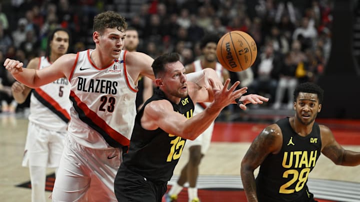 Oct 18, 2024; Portland, Oregon, USA; Utah Jazz forward Drew Eubanks (15) grabs a rebound during the second half against Portland Trail Blazers center Donovan Clingan (23) at Moda Center. Mandatory Credit: Troy Wayrynen-Imagn Images