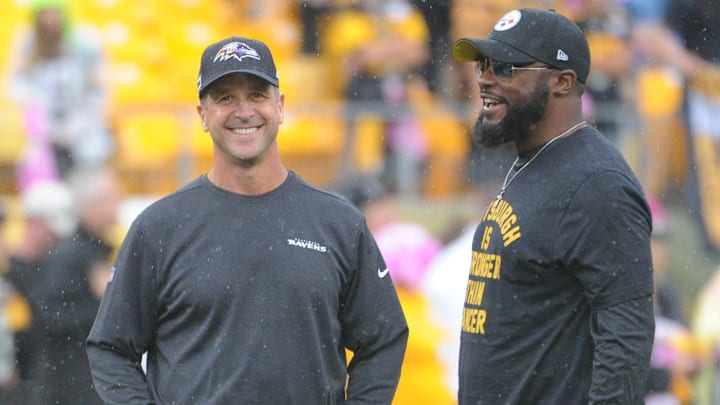 Oct 6, 2019; Pittsburgh, PA, USA; Baltimore Ravens head coach John Harbaugh (left) talks with Pittsburgh Steelers head coach Mike Tomlin before a game at Heinz Field. Mandatory Credit: Philip G. Pavely-Imagn Images